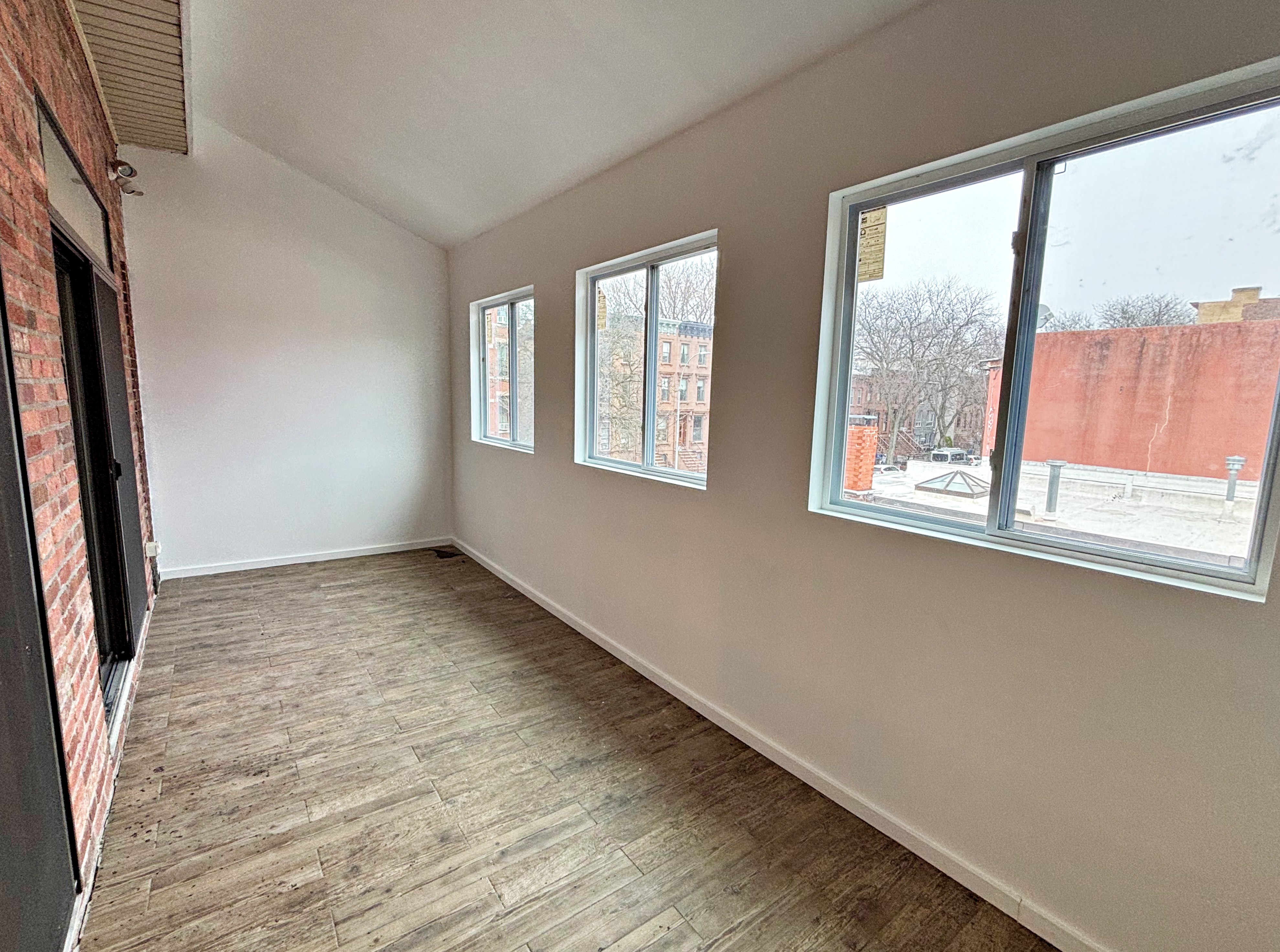 385 Nostrand Avenue, Unit Undisclosed Brooklyn, NY 11216 - Photo 24 of 27 a view of an empty room with a window