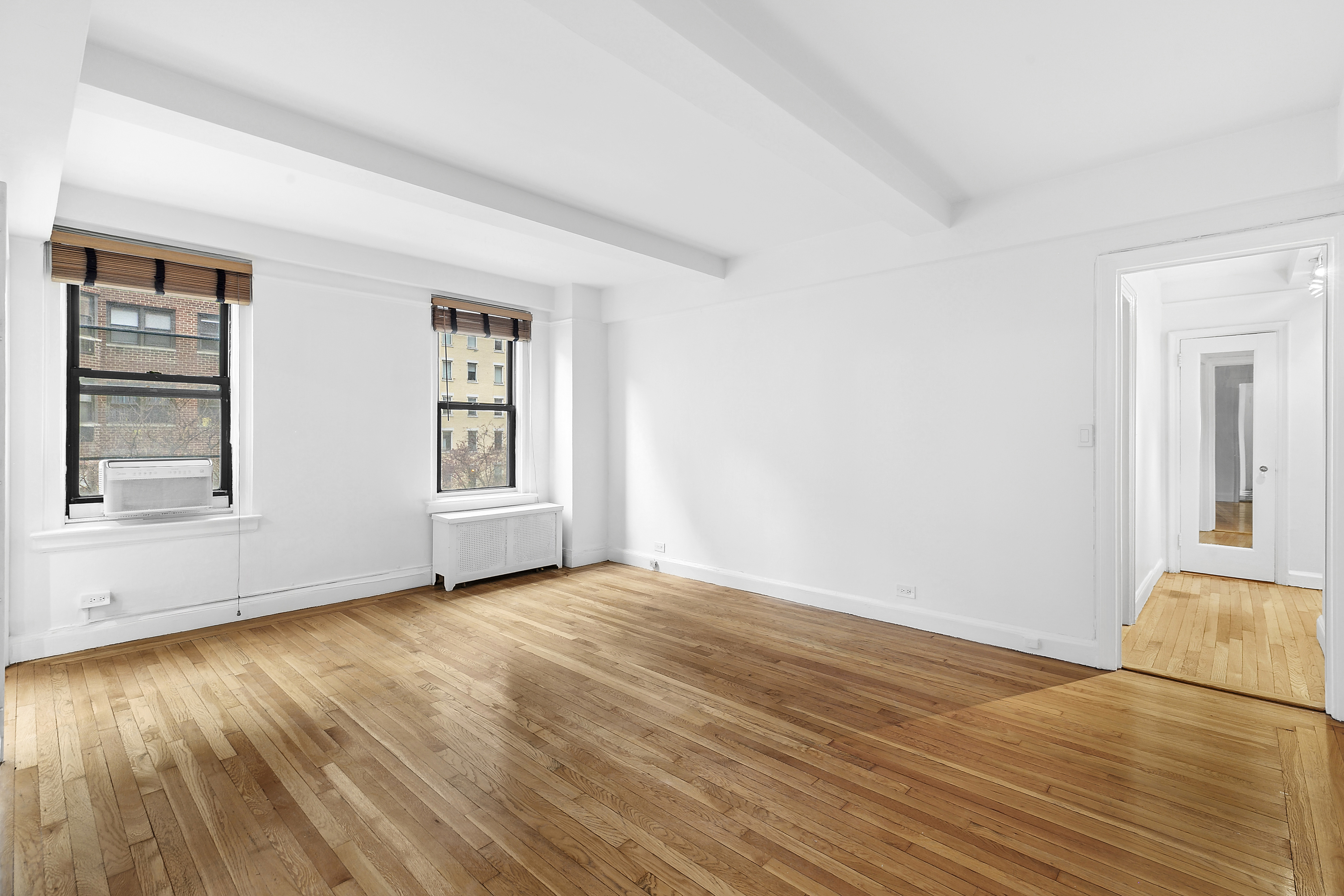 321 East 54th Street, Unit 4A Manhattan, NY 10022 - Photo 2 of 9 a view of empty room with wooden floor and fan