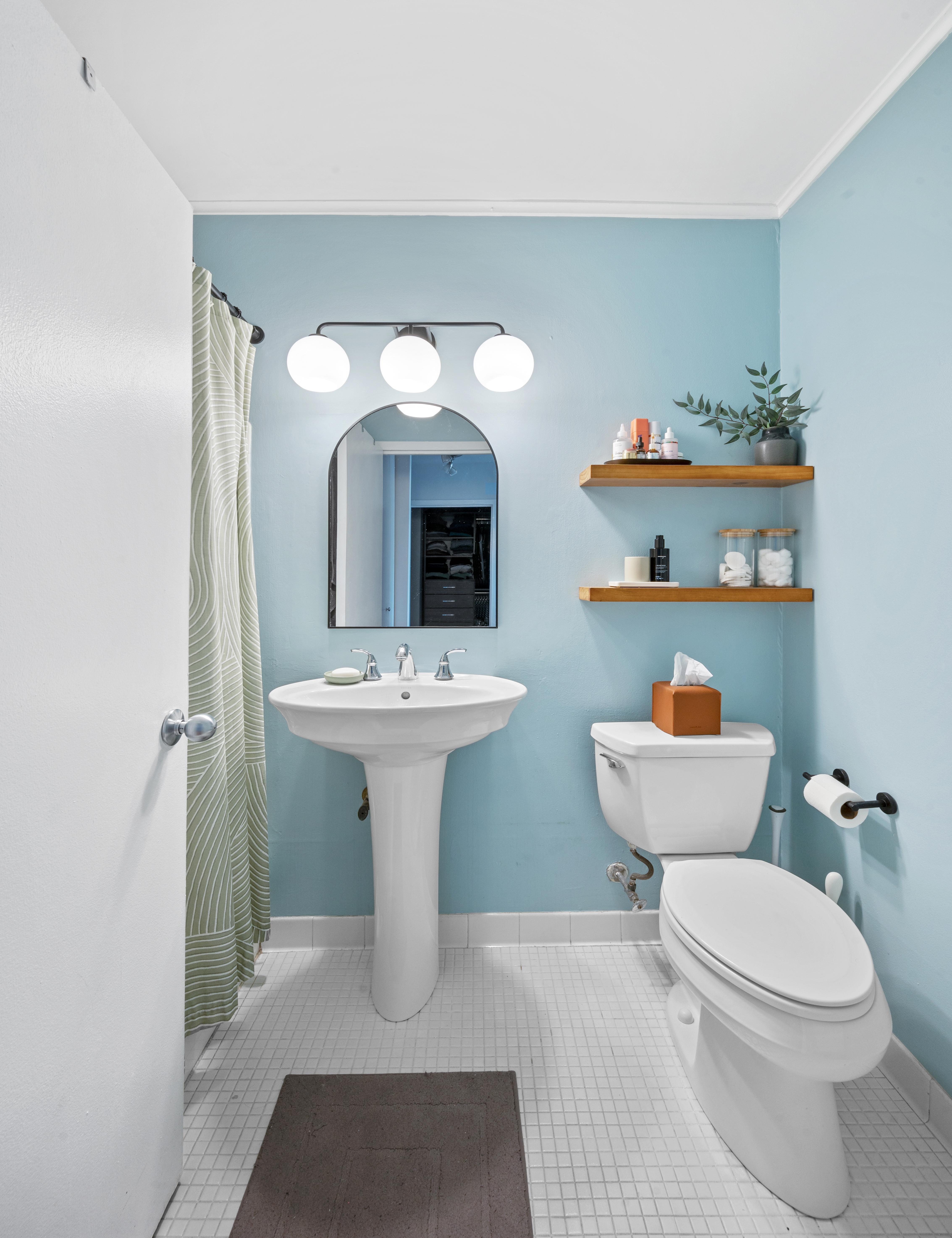 245 East 54th Street, Unit 26JK Manhattan, NY 10022 - Photo 9 of 12 a bathroom with a sink toilet and a mirror