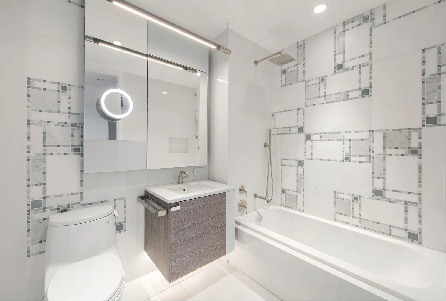 a bathroom with a sink toilet vanity and shower