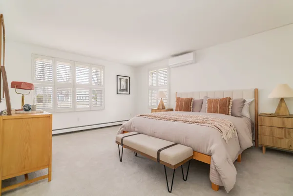 a spacious bedroom with a bed and a couch