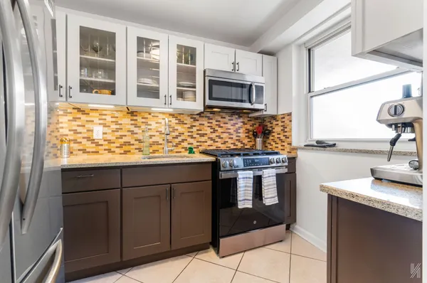 a kitchen with stainless steel appliances granite countertop a stove and a sink