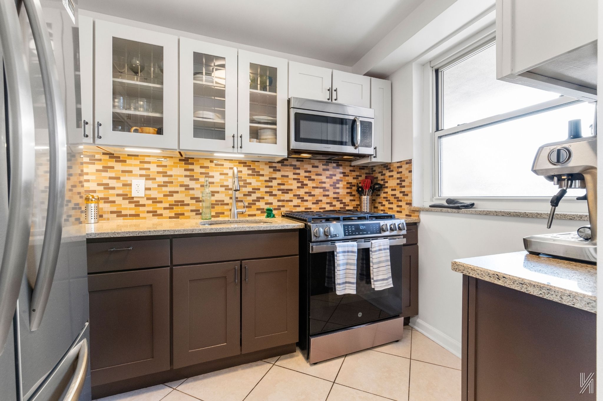 35-50 85th Street, Unit 7H Queens, NY 11372 - Photo 4 of 16 a kitchen with stainless steel appliances granite countertop a stove and a sink
