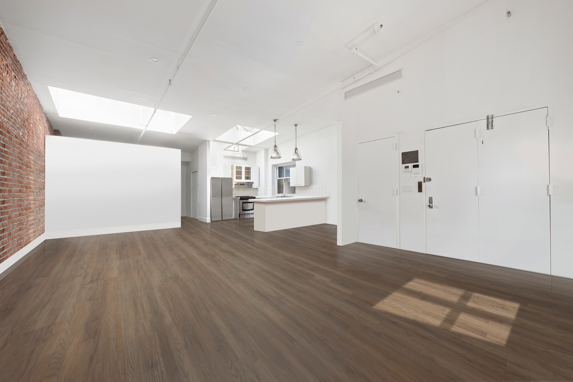 99 Spring Street, Unit PH6 Manhattan, NY 10012 - Photo 8 of 23 a view of a kitchen with wooden floor