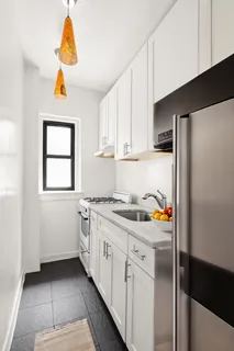 a kitchen with a sink a stove and cabinets