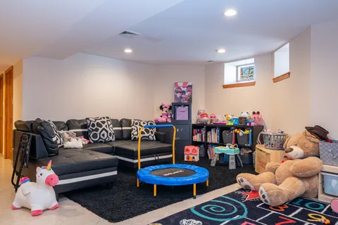 a living room with lots of furniture and a wooden floor