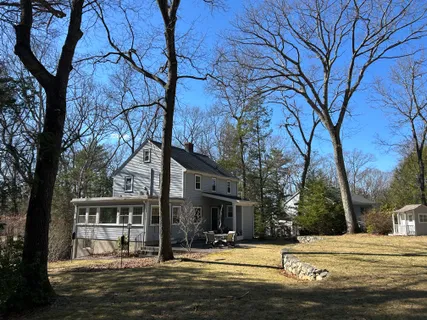 a front view of a building with trees