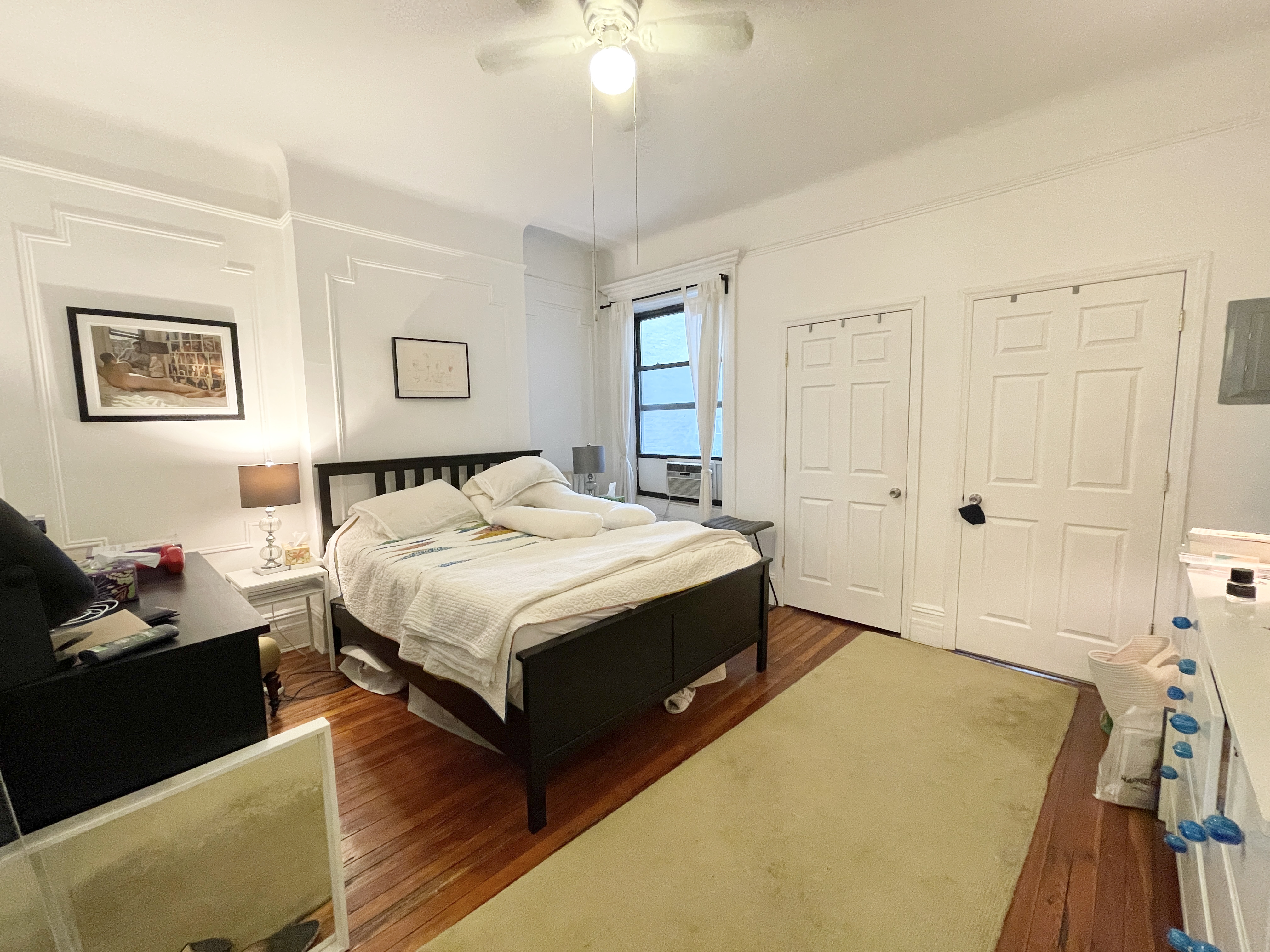 447 Jefferson Avenue, Unit 3L Brooklyn, NY 11221 - Photo 7 of 13 a spacious bedroom with a bed and a chandelier