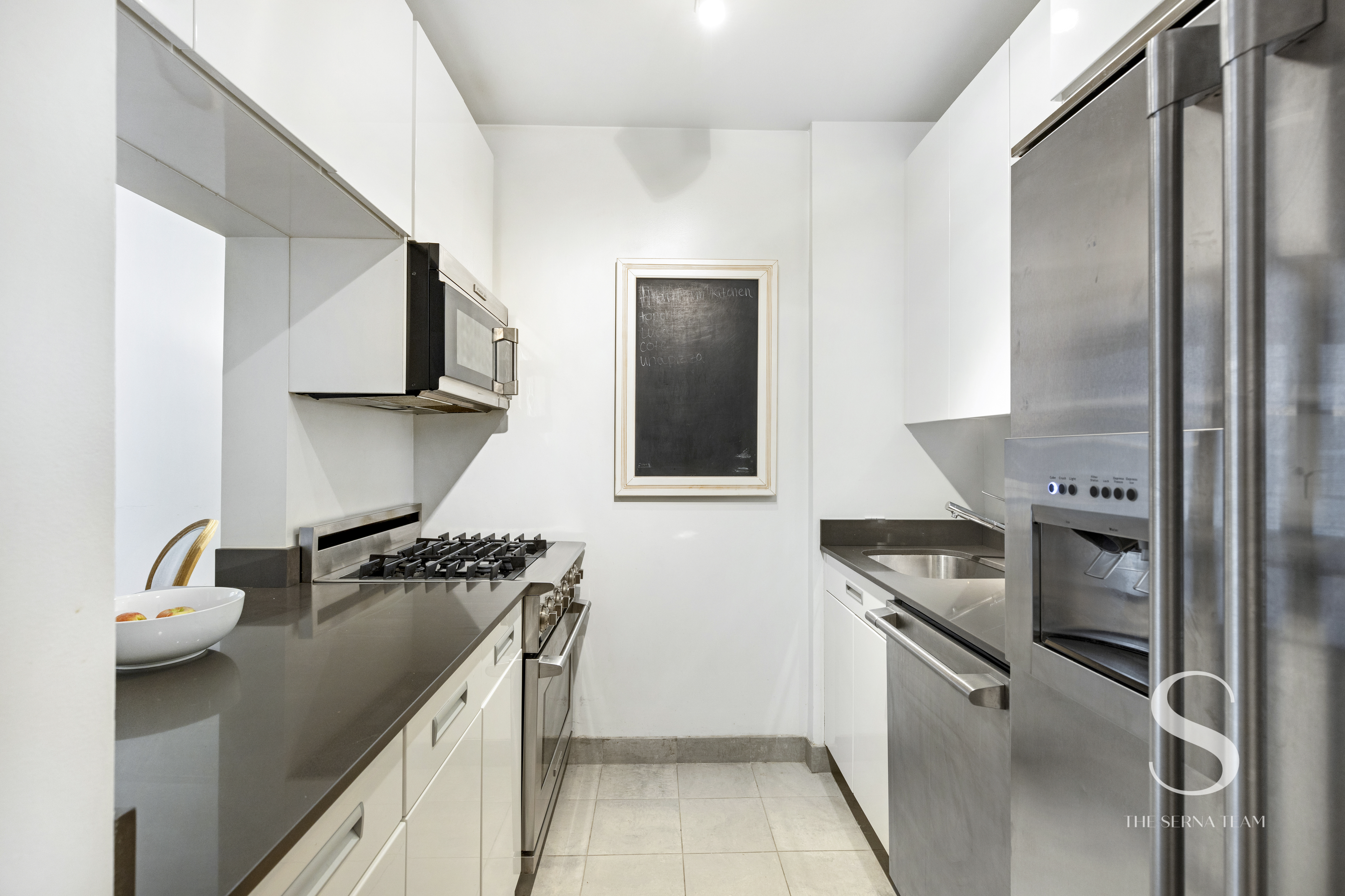 99 John Street, Unit 910 Manhattan, NY 10038 - Photo 4 of 11 a kitchen with a stove and a refrigerator