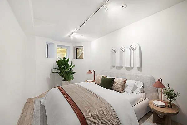 164 Sterling Street, Unit GARDEN Brooklyn, NY 11225 - Photo 3 of 5 a bedroom with a bed and a potted plant