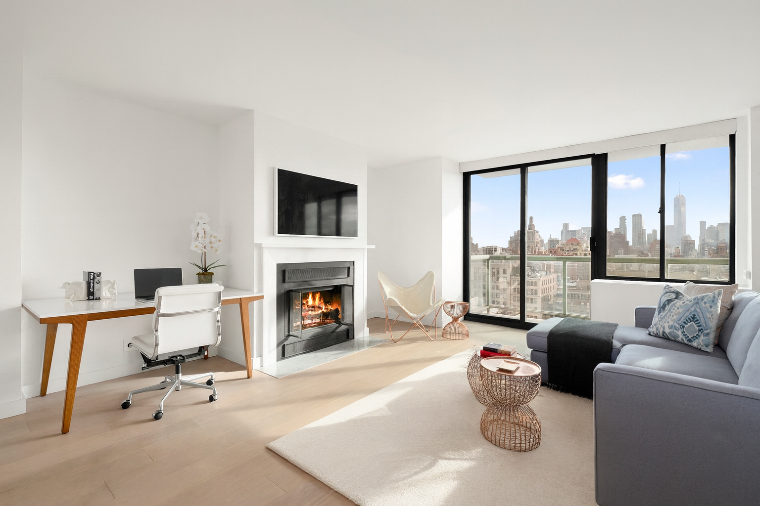 22 West 15th Street, Unit 19D Manhattan, NY 10011 - Photo 2 of 18 a living room with furniture and a fireplace