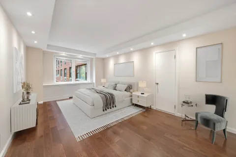 a spacious bedroom with a bed and a couch