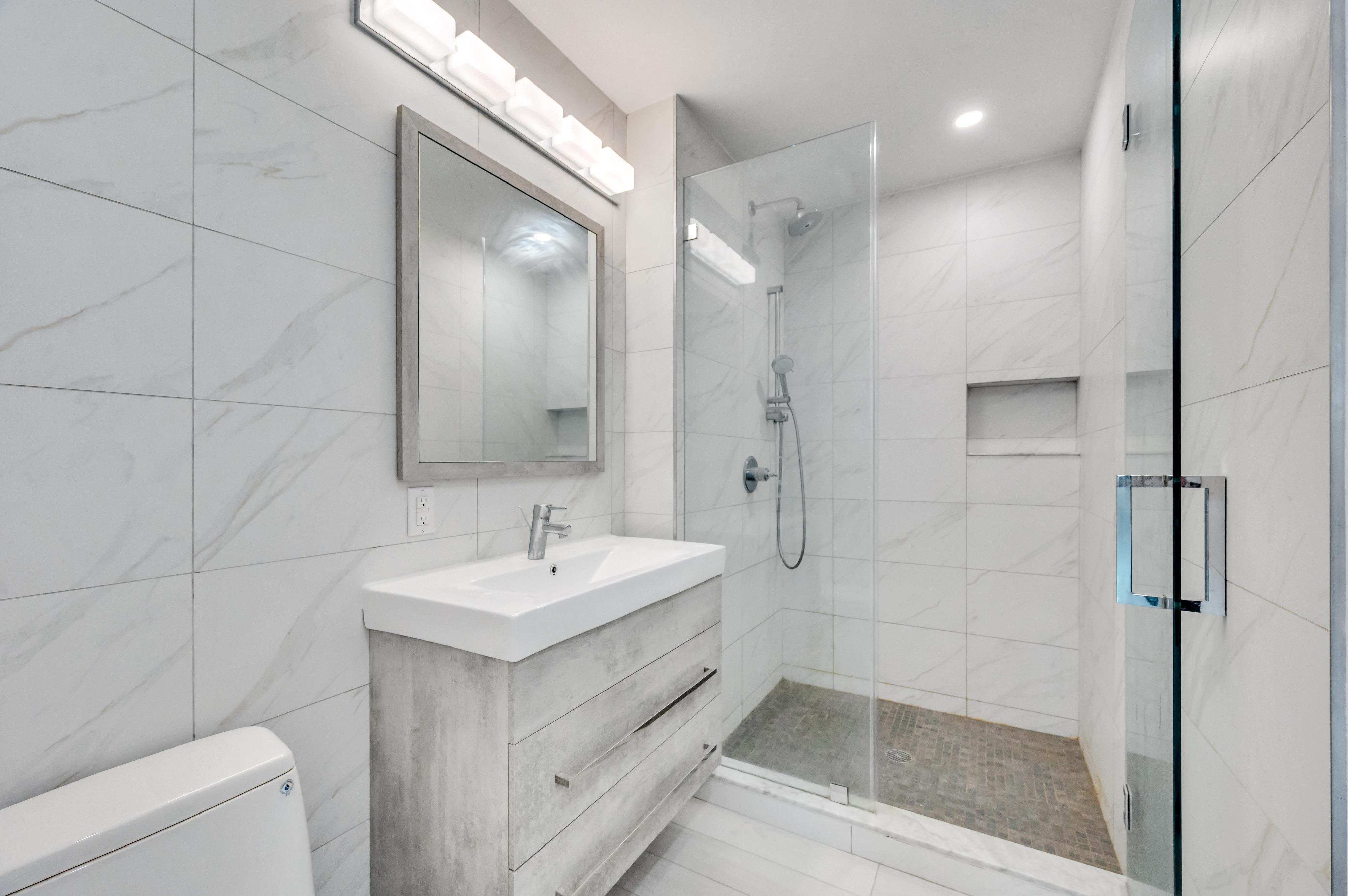 717 Manhattan Avenue, Unit 3A Brooklyn, NY 11222 - Photo 12 of 18 a bathroom with a sink a toilet and shower