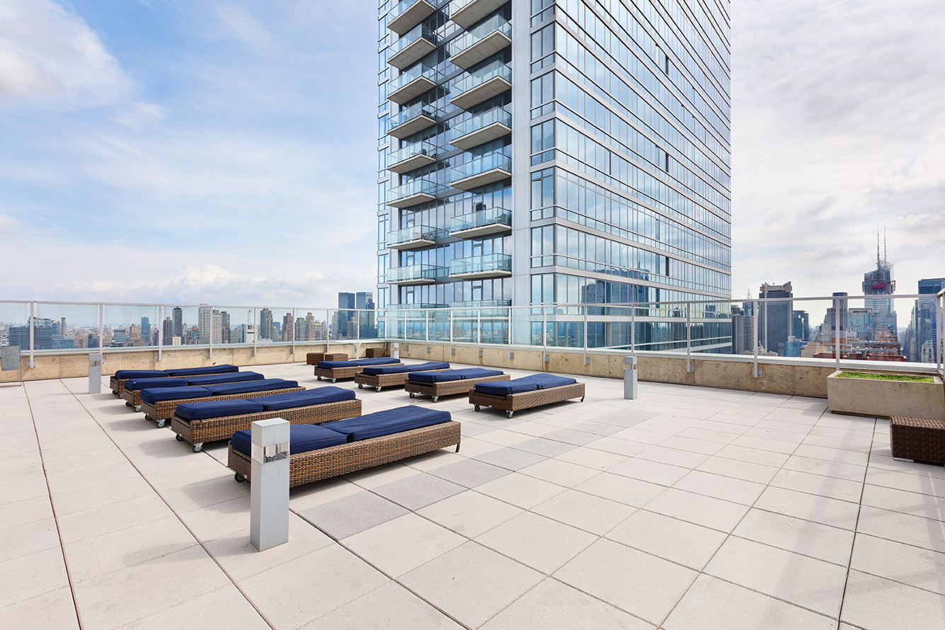 635 West 42nd Street, Unit 17D Manhattan, NY 10036 - Photo 5 of 6 a outdoor space with patio area and swimming pool