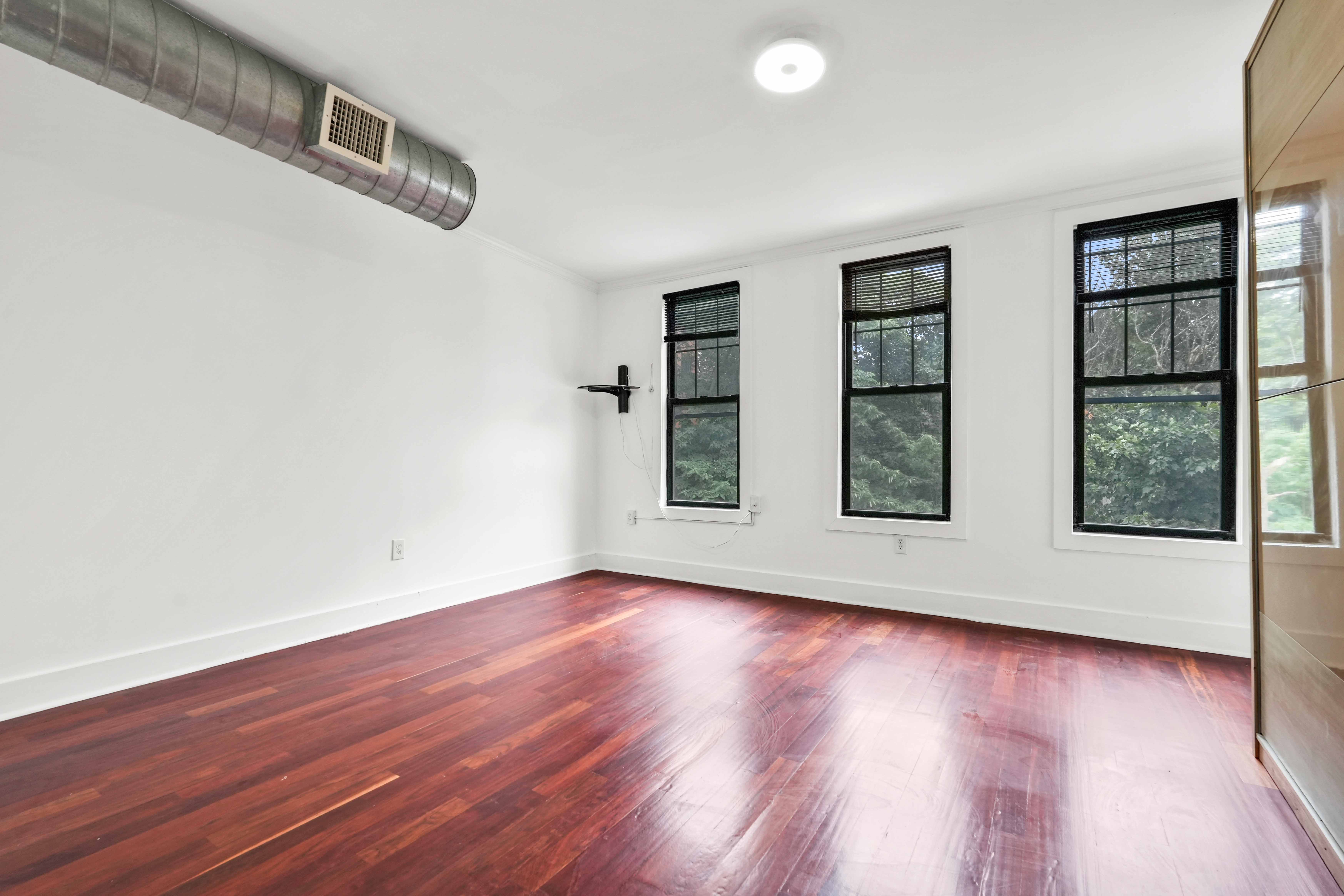 17 A Suydam Place, Unit 2 Brooklyn, NY 11233 - Photo 14 of 28 a view of an empty room with wooden floor and windows