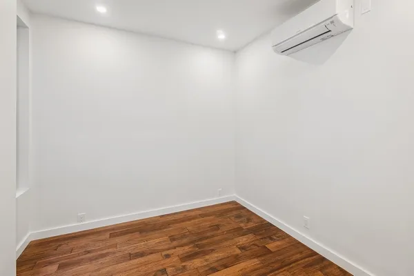 a view of room with wooden floor
