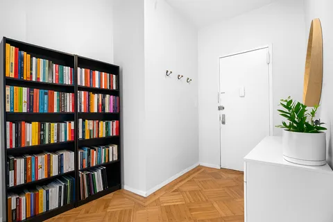 a bedroom with a bed and a book shelf