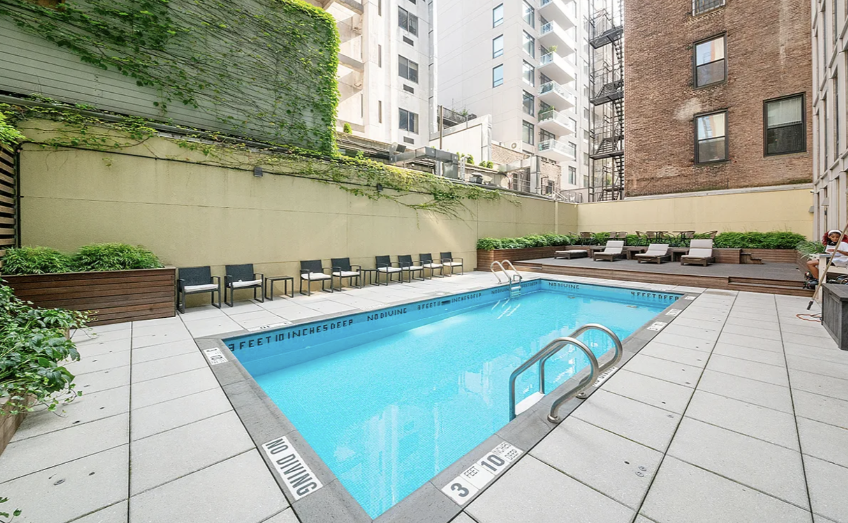 133 West 22nd Street, Unit 7H Manhattan, NY 10011 - Photo 17 of 21 a swimming pool with outdoor seating and yard