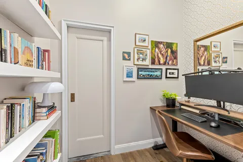 a view of a workspace with furniture and stairs