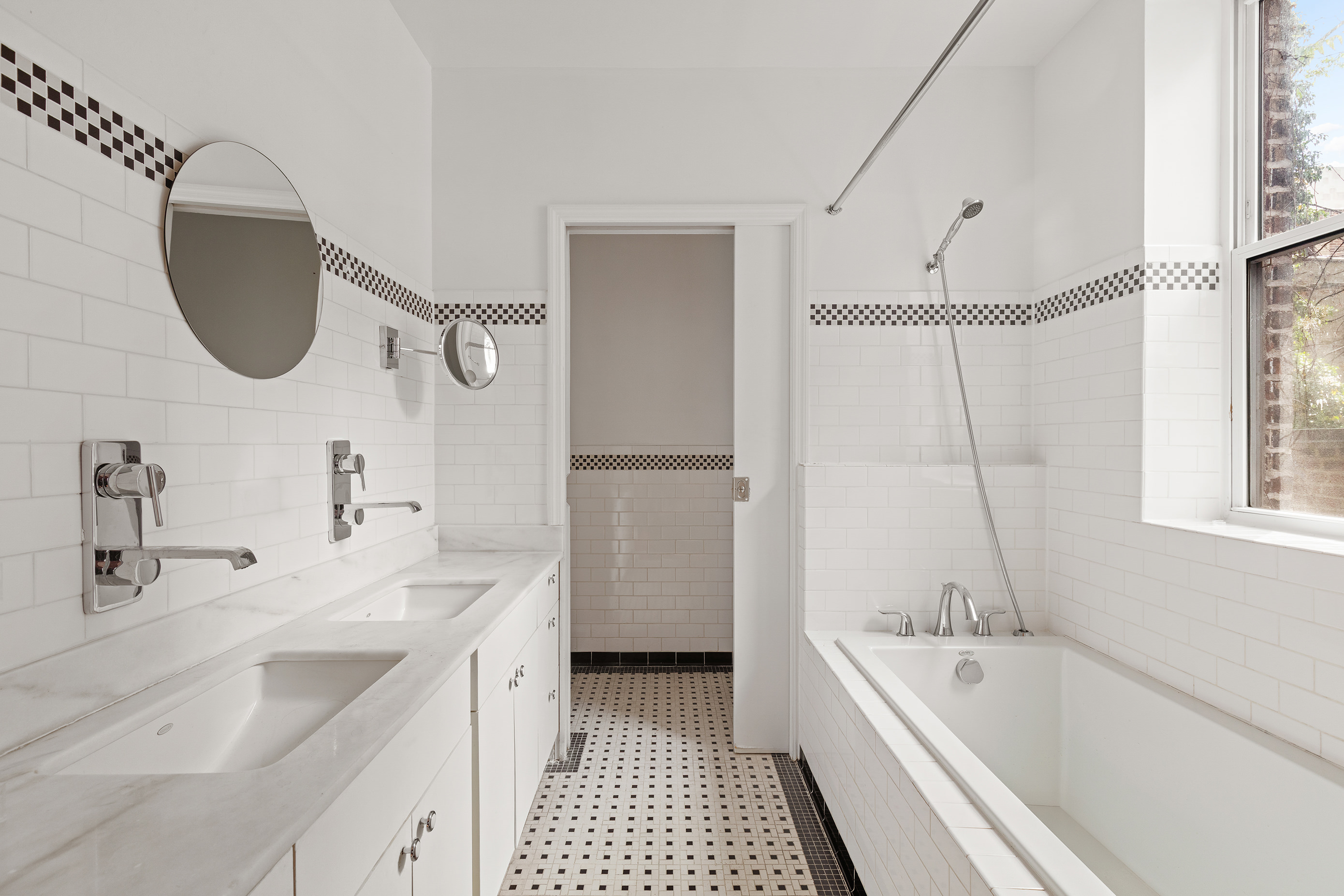 126 East 19th Street Manhattan, NY 10003 - Photo 9 of 13 a bathroom with a tub sink and mirror
