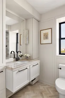 a bathroom with a toilet sink and mirror