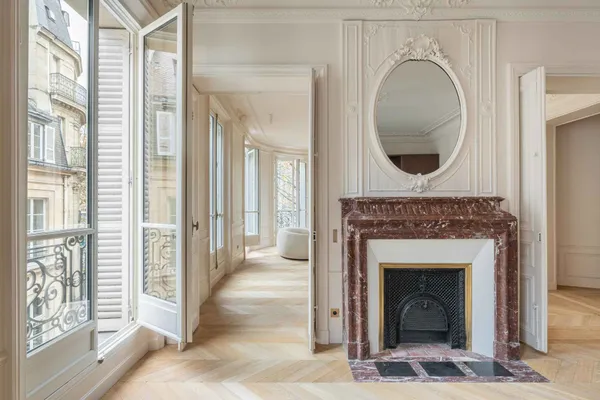 a view of a livingroom with a fireplace and window
