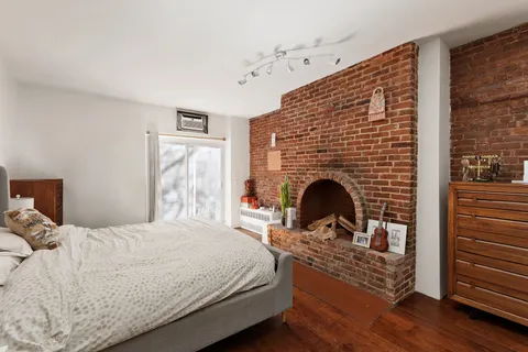 a bedroom with a bed and a fireplace