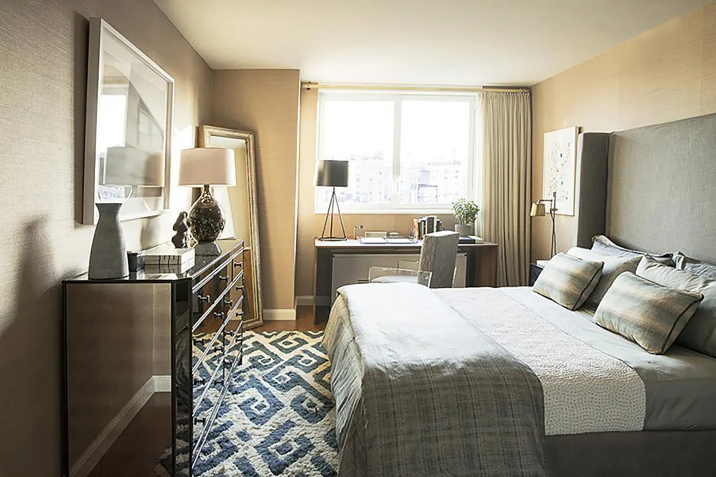 a bedroom with a bed and glass windows