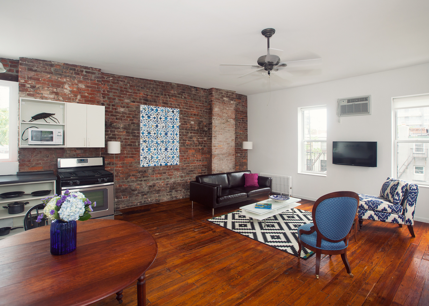 5-46 50th Avenue Queens, NY 11101 - Photo 5 of 17 a living room with furniture and a flat screen tv