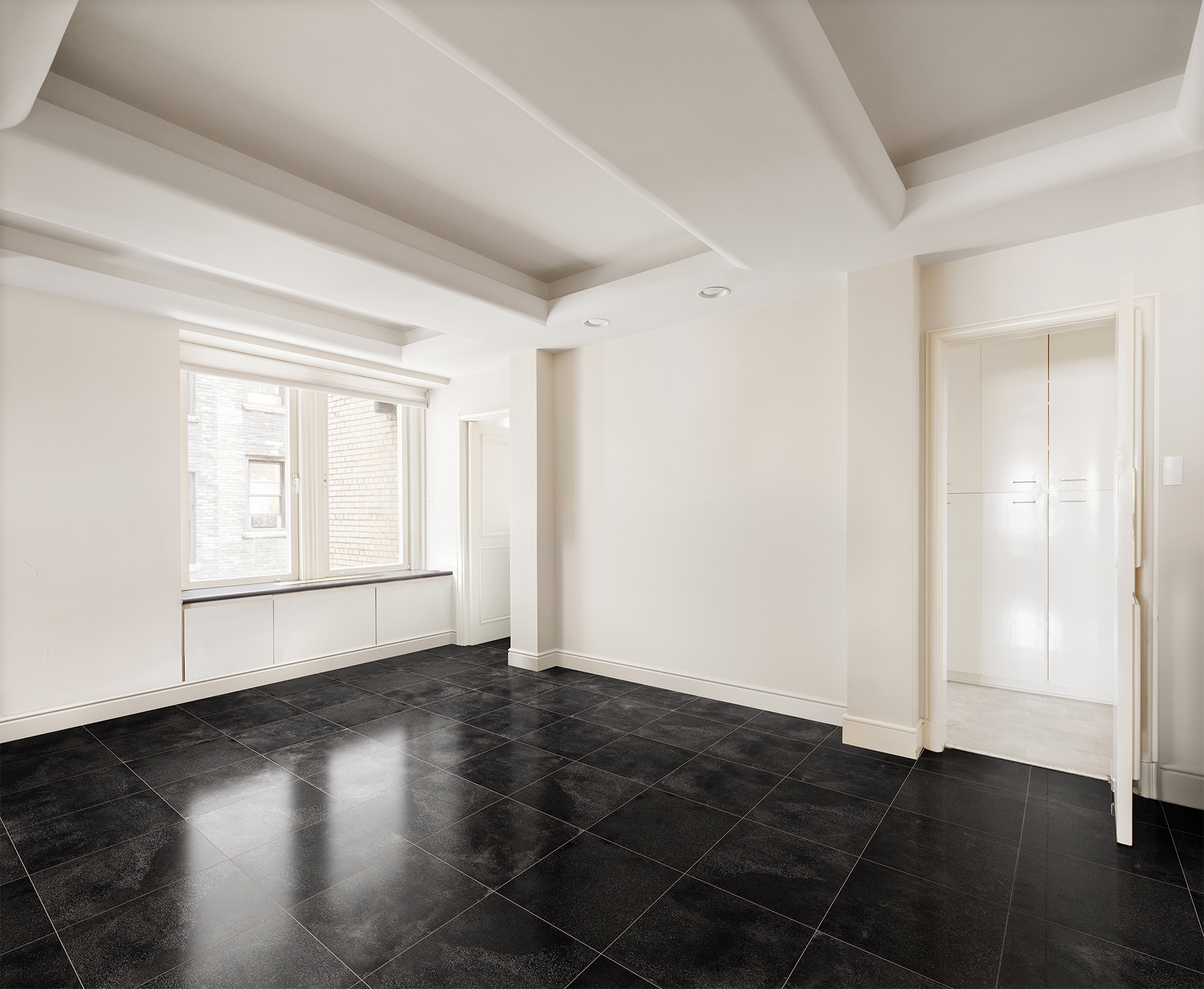 130 East 75th Street, Unit 4D Manhattan, NY 10021 - Photo 6 of 19 an empty room with wooden floor and windows