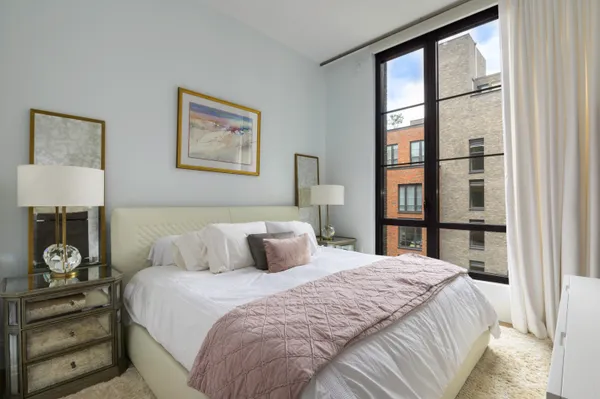 a bedroom with a large bed and a window
