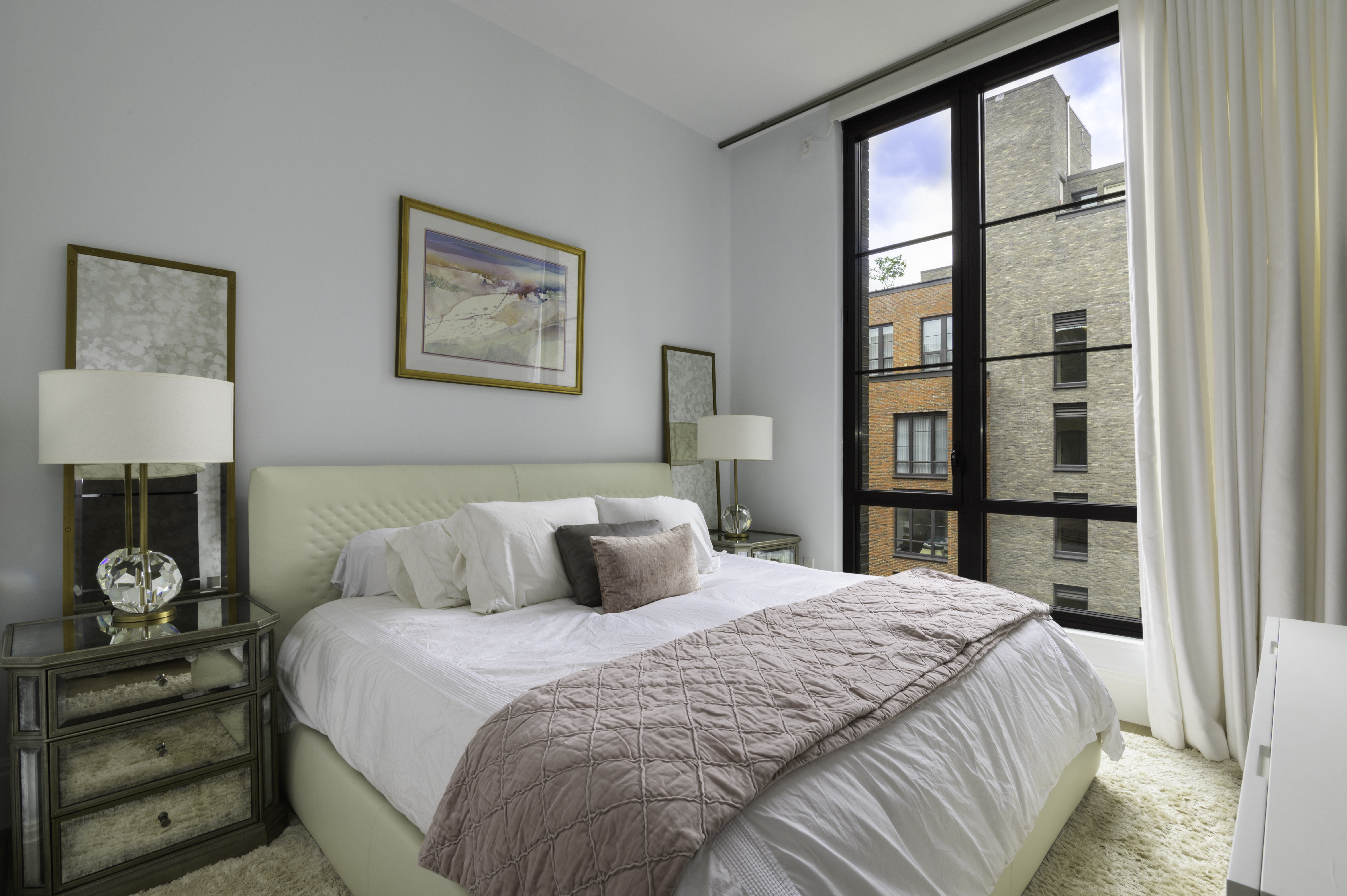 438 East 12th Street, Unit 6J Manhattan, NY 10009 - Photo 3 of 14 a bedroom with a large bed and a window