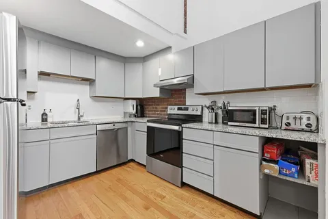 a kitchen with a refrigerator and a sink