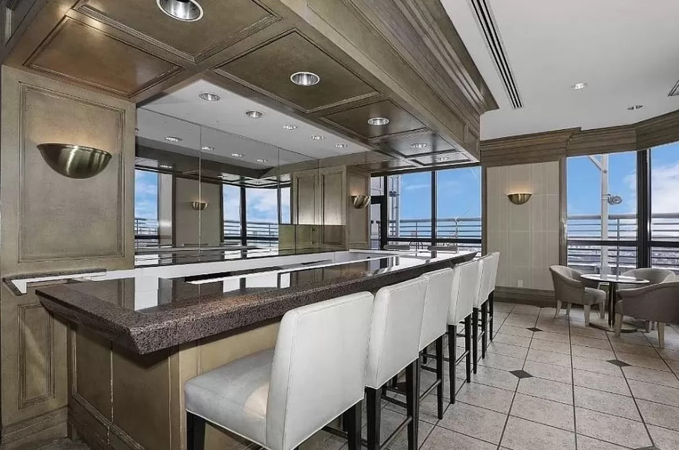 415 East 37th Street, Unit 32G Manhattan, NY 10016 - Photo 9 of 19 a kitchen with granite countertop a table and chairs