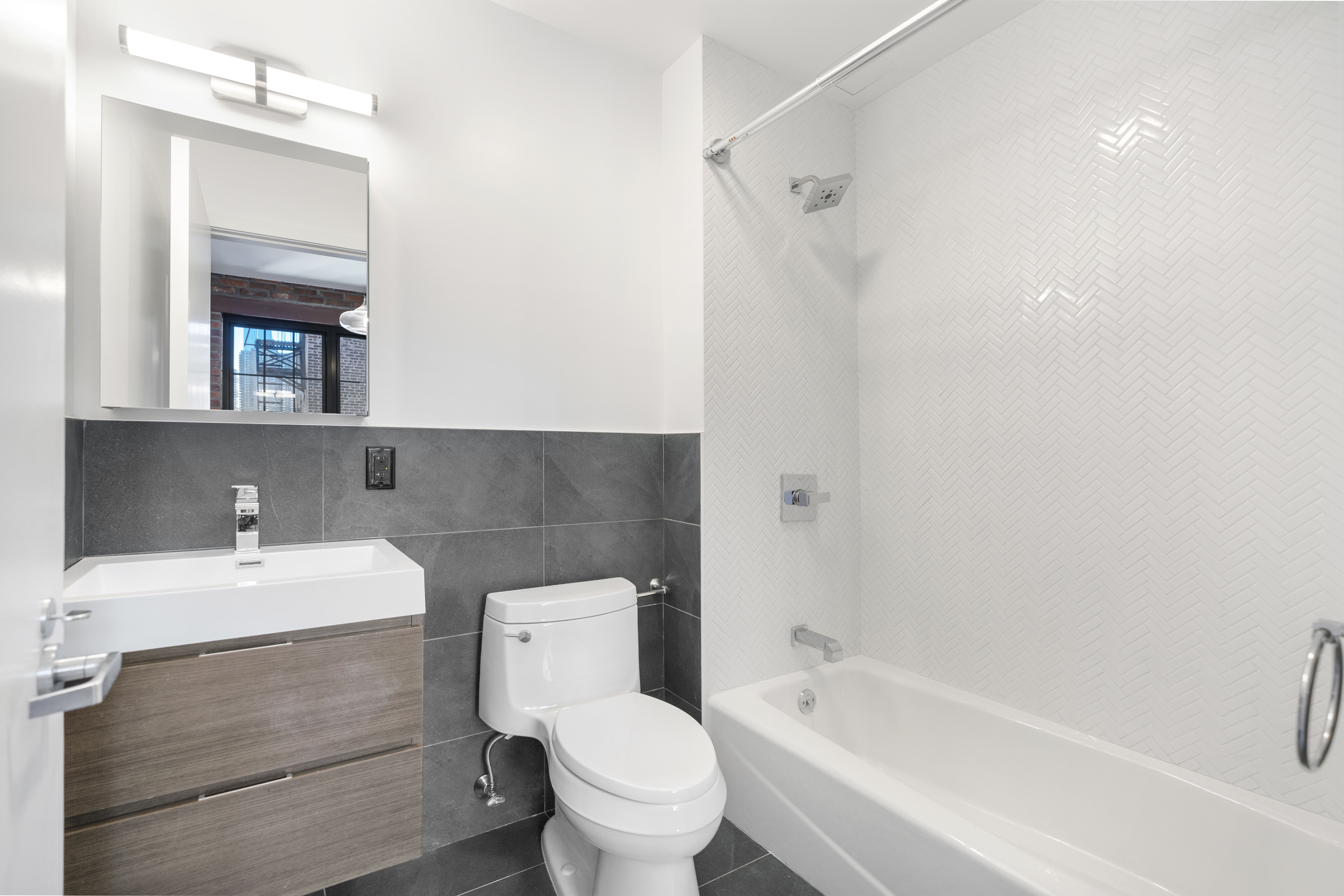 406 West 52nd Street, Unit 2 Manhattan, NY 10019 - Photo 5 of 9 a bathroom with a sink toilet and shower