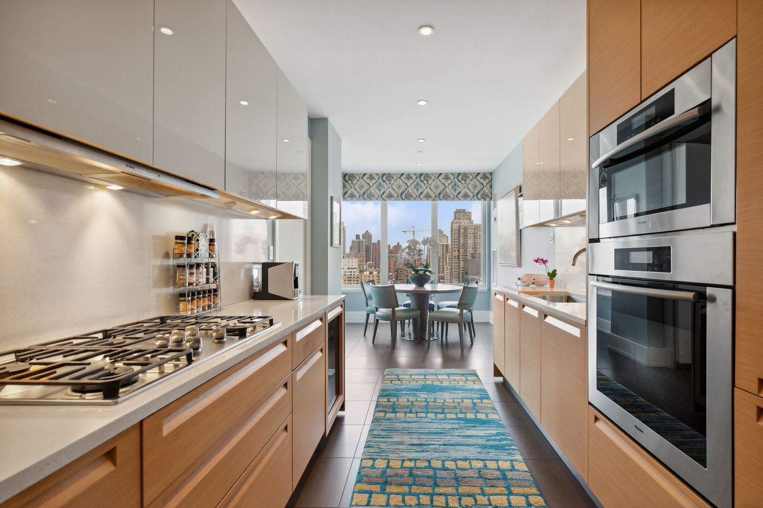 255 East 74th Street, Unit 20C Manhattan, NY 10021 - Photo 4 of 16 a kitchen with stainless steel appliances a stove a sink and a refrigerator