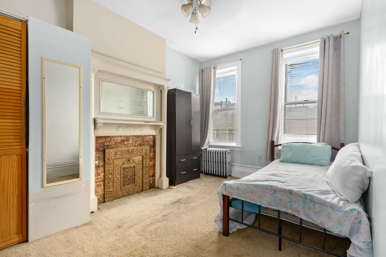 a bedroom with a bed dresser and a window