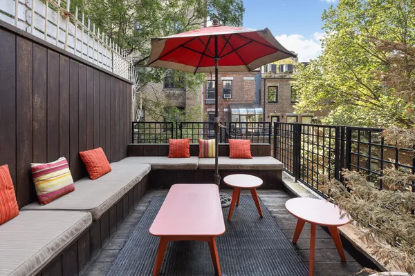 a outdoor sitting area with furniture and wooden floor