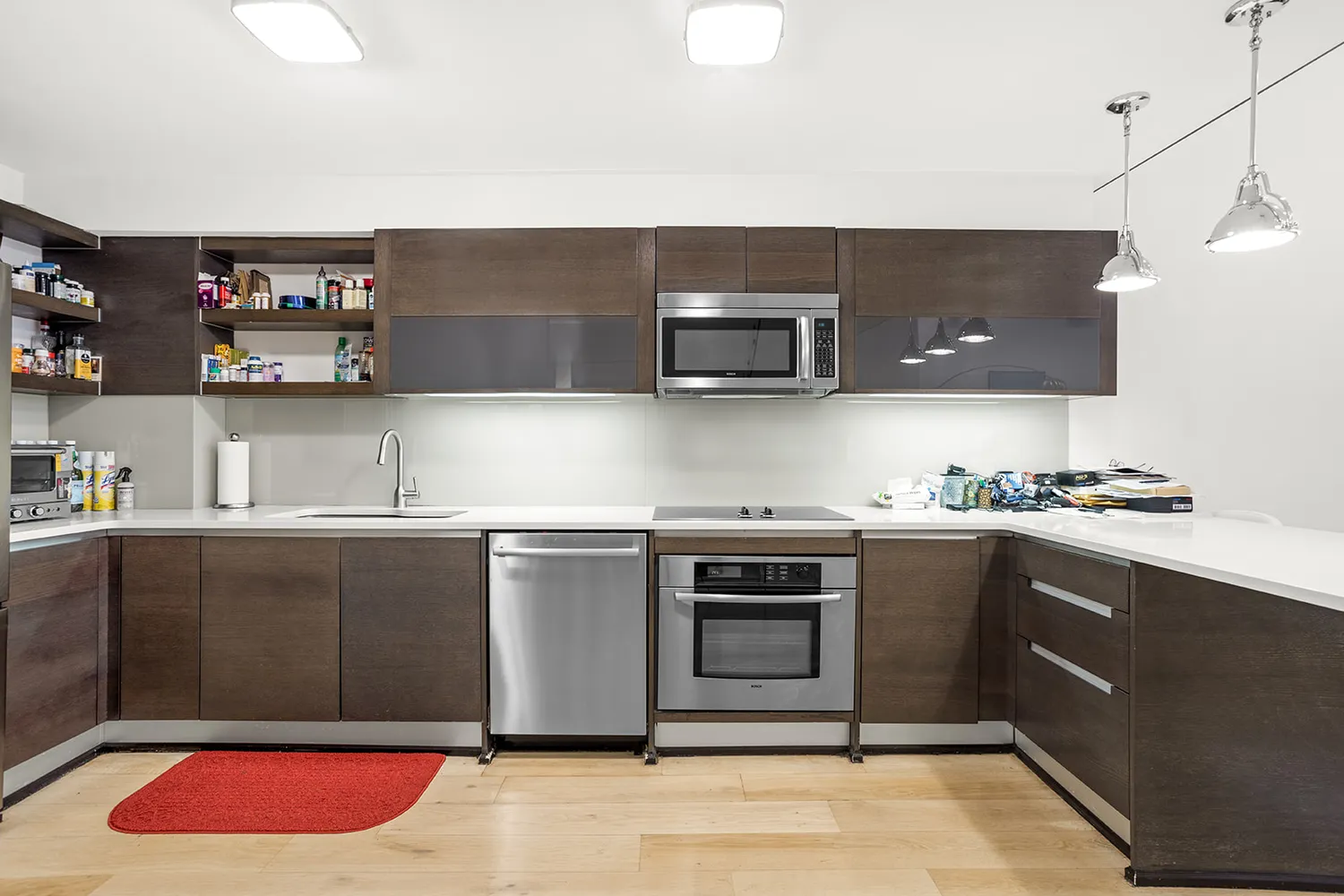 a kitchen with stainless steel appliances granite countertop a sink and a stove