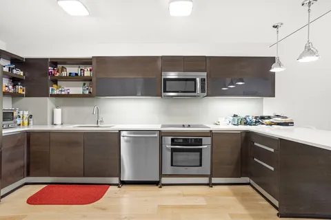 a kitchen with stainless steel appliances granite countertop a sink and a stove