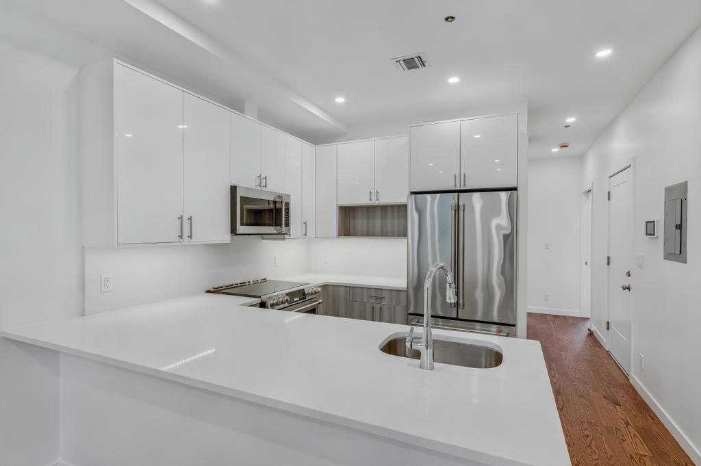 109 President Street, Unit 4 Brooklyn, NY 11231 - Photo 2 of 22 a kitchen with stainless steel appliances granite countertop a refrigerator and a sink