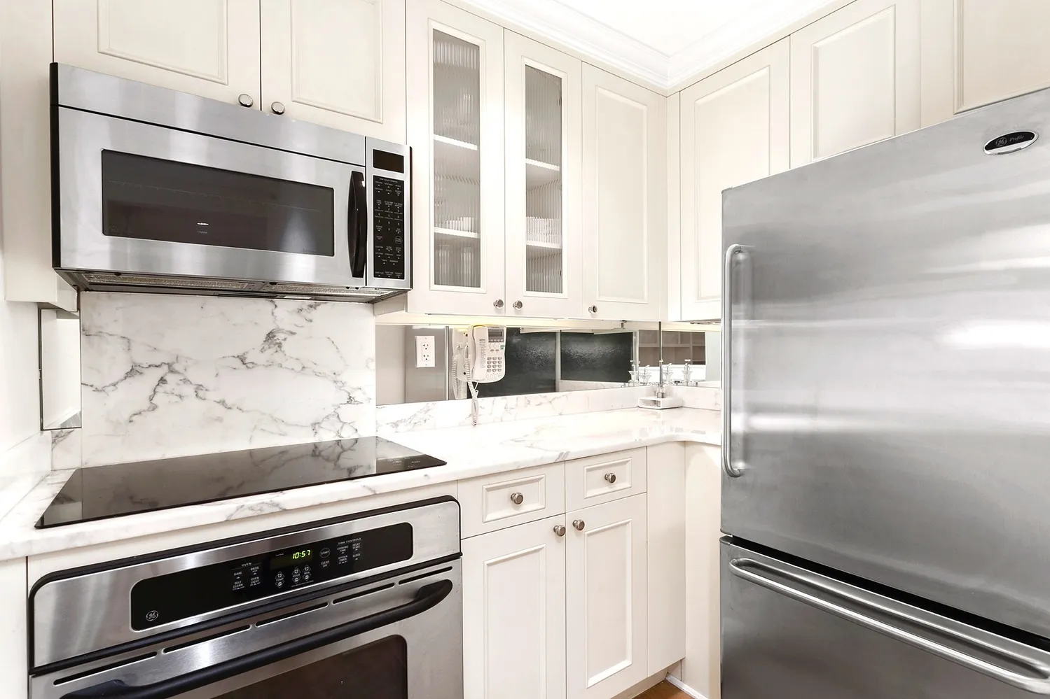 a kitchen with granite countertop cabinets stainless steel appliances and a counter space
