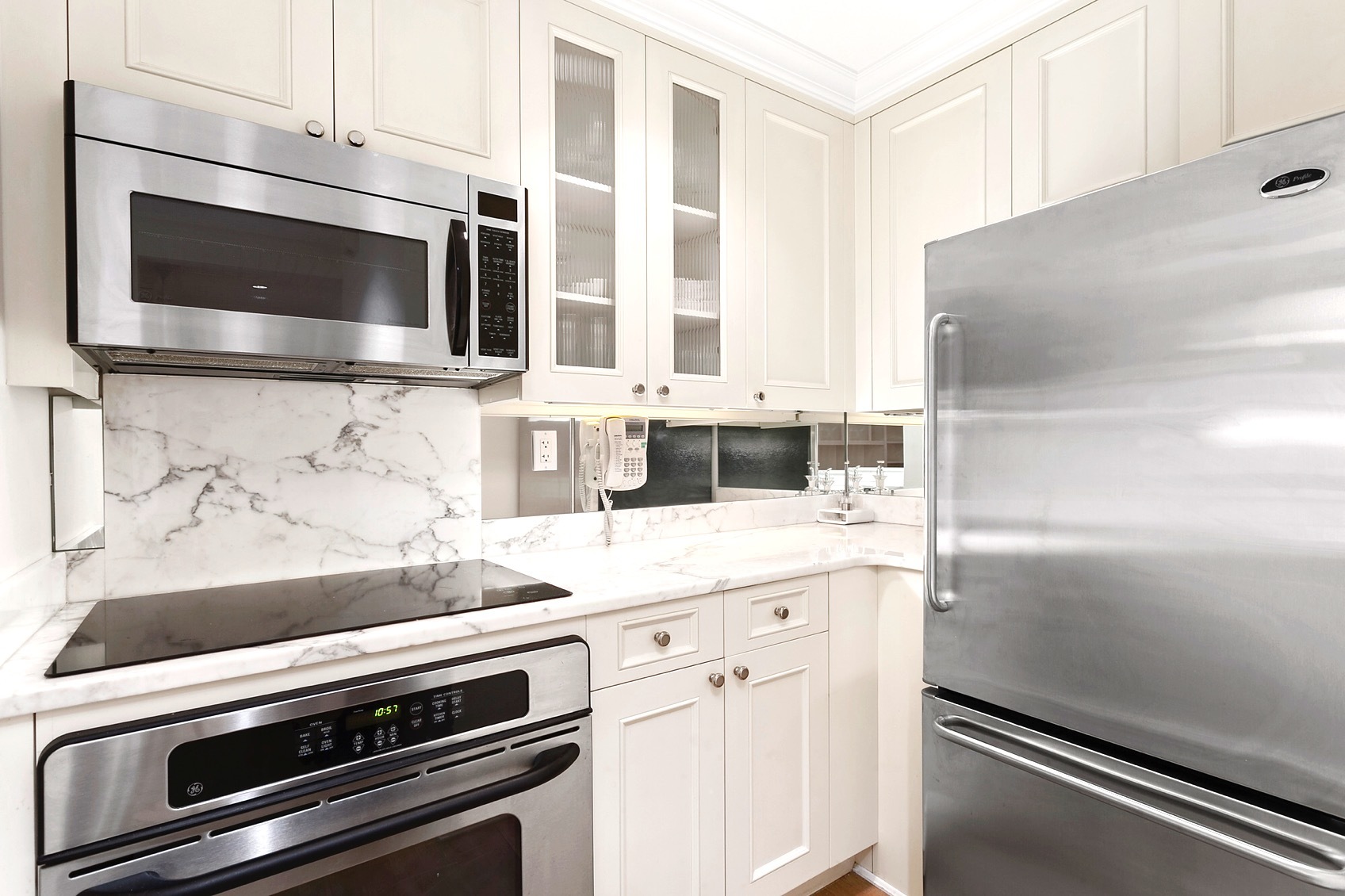 502 Park Avenue, Unit 9A Manhattan, NY 10022 - Photo 3 of 9 a kitchen with granite countertop cabinets stainless steel appliances and a counter space