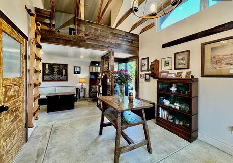 a view of a room with lots of wooden furniture