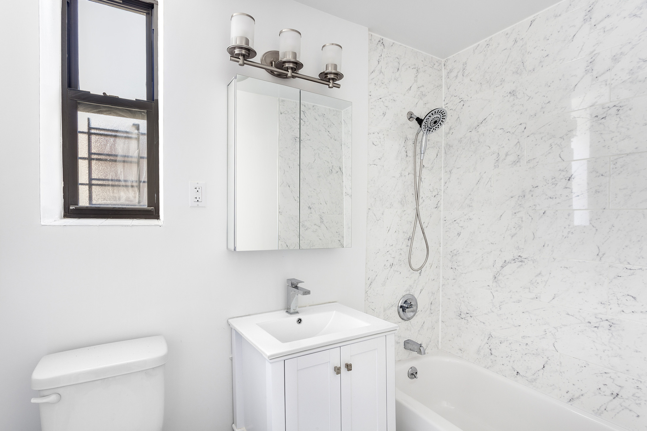 660 St Nicholas Avenue, Unit 63 Manhattan, NY 10030 - Photo 9 of 14 a bathroom with a sink a toilet and shower