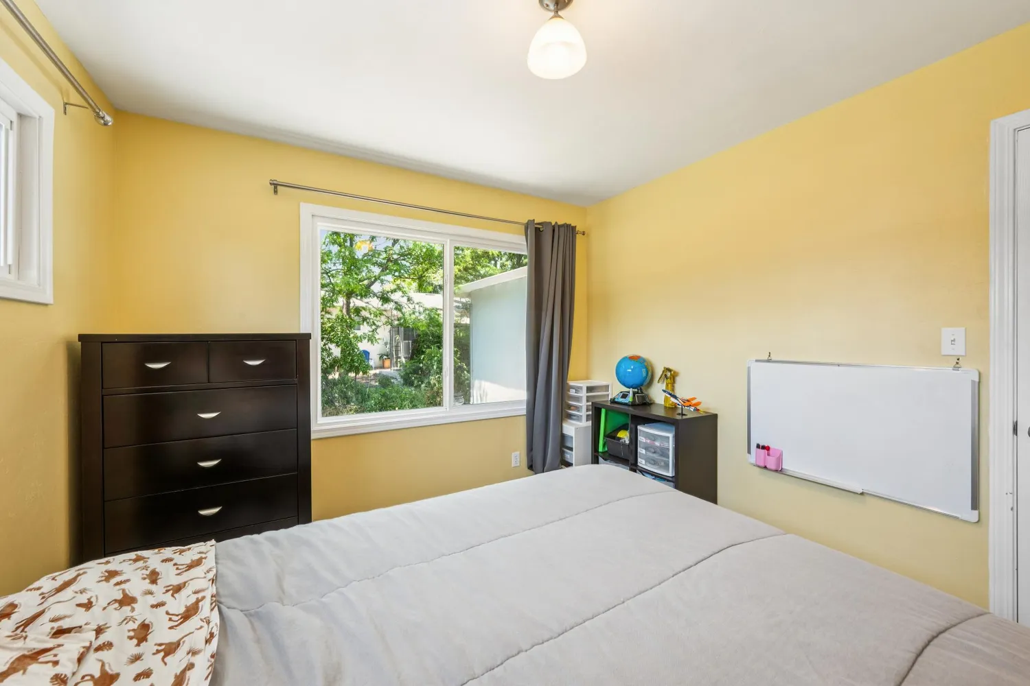 a backyard of a house with large trees and a small yard