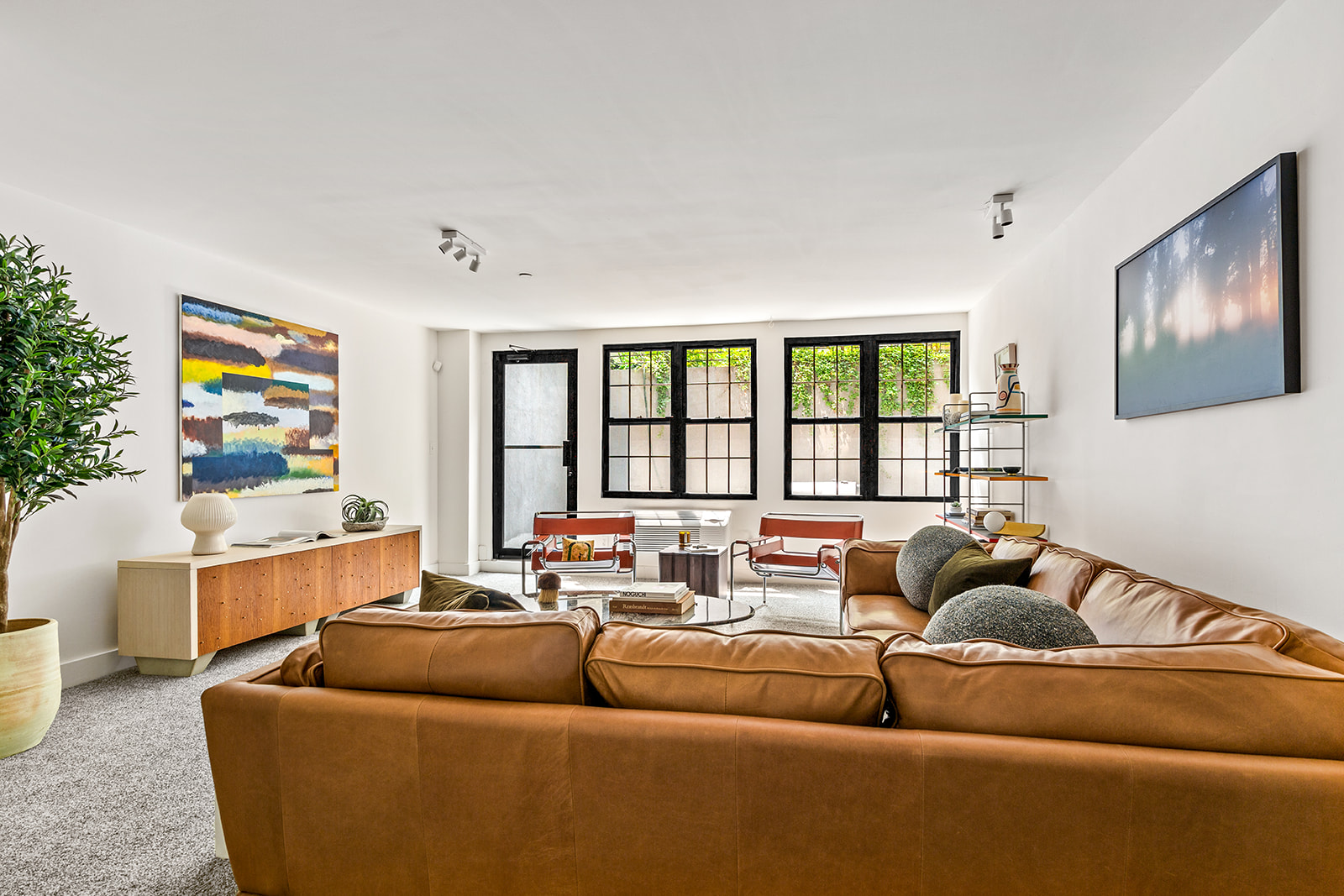 120 Pulaski Street, Unit 1B Brooklyn, NY 11206 - Photo 2 of 13 a living room with furniture and a large window