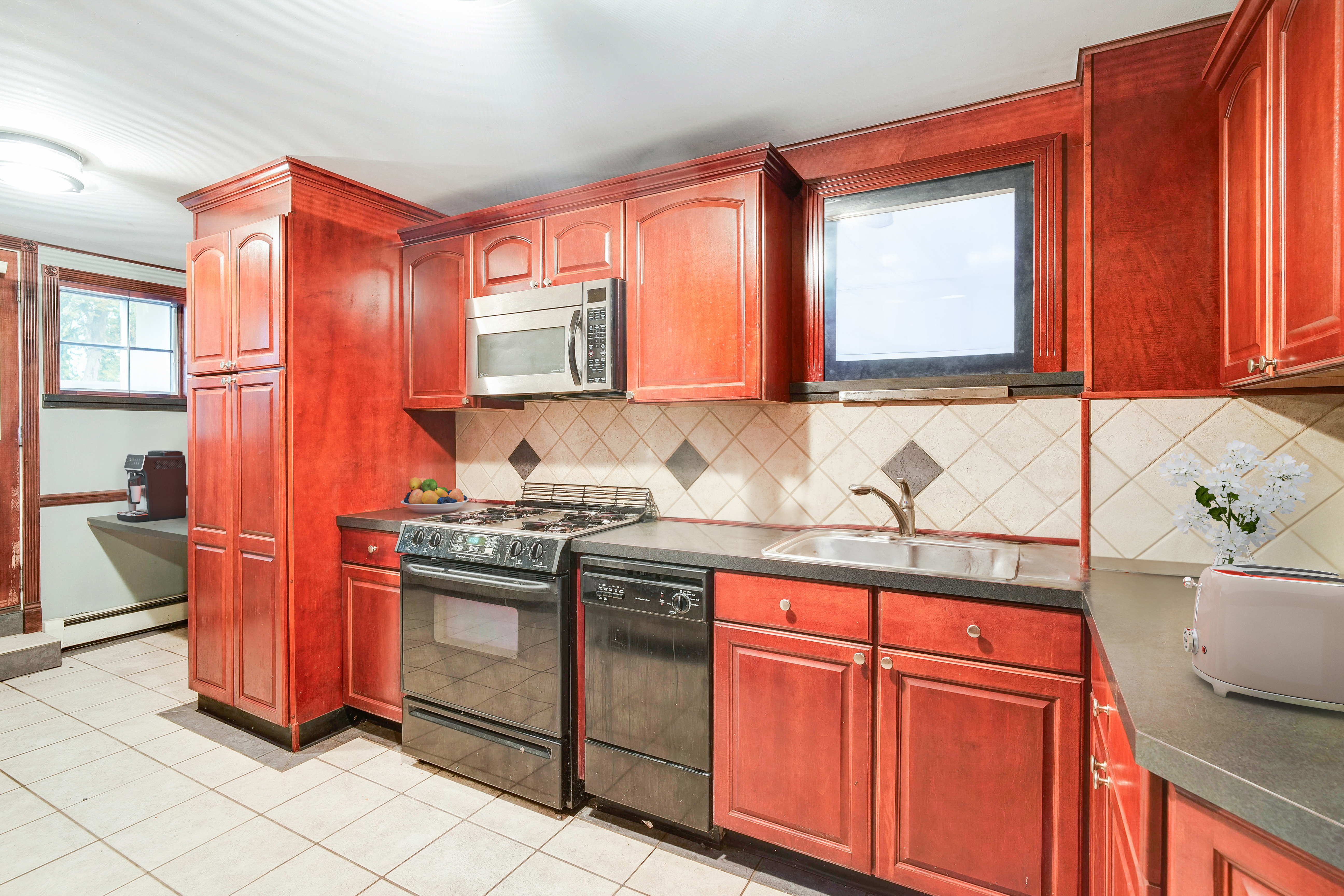 233 Battery Avenue Brooklyn, NY 11209 - Photo 13 of 26 a kitchen with stainless steel appliances granite countertop a sink stove and cabinets