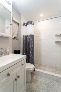 a bathroom with a sink a toilet and a shower