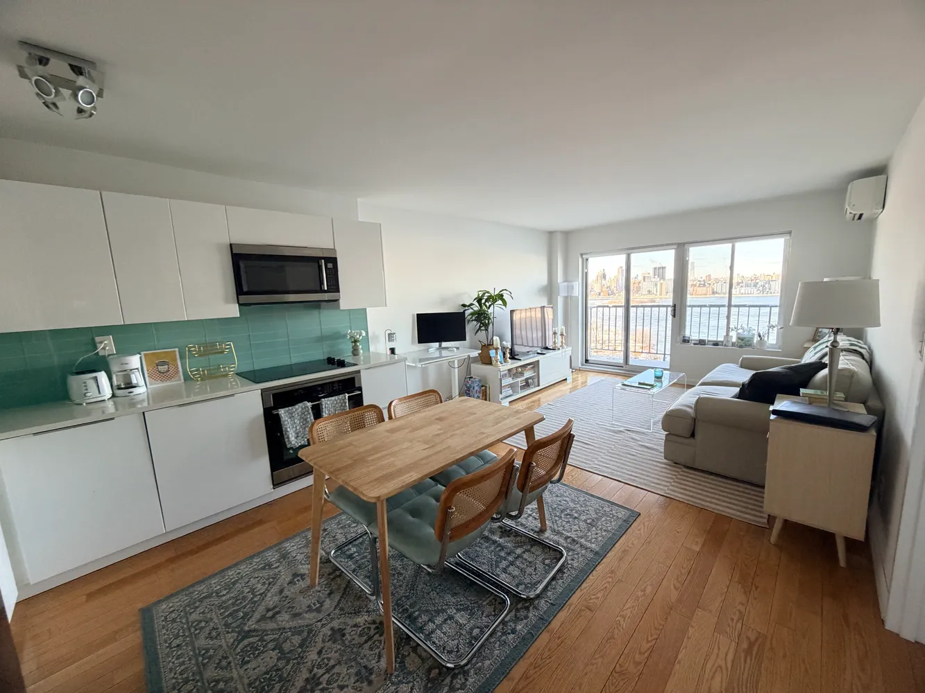 a living room with furniture and a wooden floor
